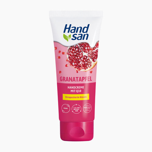 Handsan Hand Cream in a squeeze tube with a pomegranate flavor, featuring a white top section, a pink lower section with a pomegranate graphic, and a bright pink cap, shown on a light gray background.