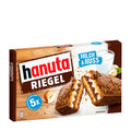 A box of hanuta Riegel wafer bars with hazelnut and milk cream layers, coated with milk chocolate. The box indicates a pack of 5 and shows an image of the wafer bar with hazelnuts.