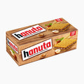 A rectangular box of Hanuta hazelnut slice wafer bars on a plain light gray background. The box has a woodgrain design with images of two wafers filled with brown cream and nuts, and the brand name 'hanuta' in large red and black letters on white labels.