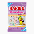 A bag of Haribo Chamallows Witch hats share-size candy, featuring a purple and blue wrapper with the Haribo logo, illustrations of a yellow bear and a purple hat on a broom, and pastel-colored marshmallow candies visible through the clear window.