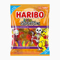 A package of Haribo Crazy Skeletties gummy candies, featuring a bright orange bag with a cartoon skeleton, a yellow bear, and a clear window showing the colorful gummy candies inside.
