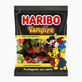 A bag of Haribo Vampire fruit gummies and licorice candy, featuring the iconic black packaging with red and yellow branding and illustrations of vampire characters.