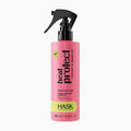 A pink bottle of HASK Heat Protect Thermal Mist with a black spray nozzle and a lime green label band, shown on a clean white background.