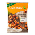 Package of Seeberger hazelnuts on a wooden surface with an orange label.