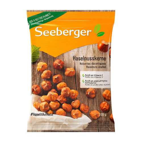Package of Seeberger hazelnuts on a wooden surface with an orange label.
