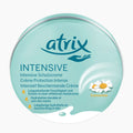 A round tin of Atrix Intensive Hand Cream with a light teal-green lid featuring the brand name 'atrix' in dark teal, product details in German, and a camomile flower illustration on the right side.