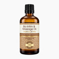 An amber glass bottle of Bio Intim & Massage Oil Clove & Cinnamon by Coconutoil Cosmetics, featuring a black ribbed cap and a brown and cream label, set against a plain white background.