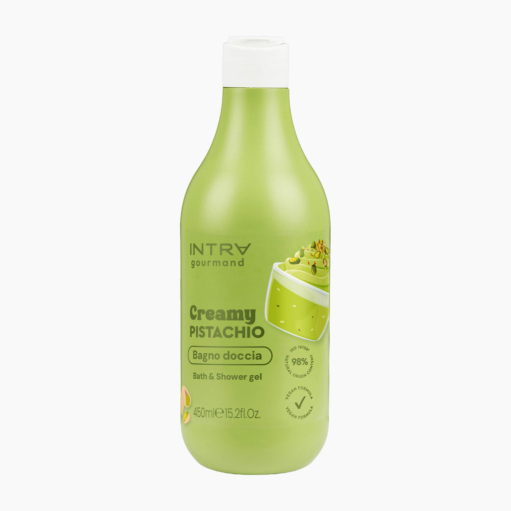 A bottle of INTRA gourmand Creamy Pistachio Bath & Shower Gel, featuring a light green translucent bottle with a white cap and a matching pistachio-themed label, set against a plain white background.