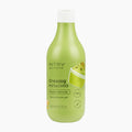 A bottle of INTRA gourmand Creamy Pistachio Bath & Shower Gel, featuring a light green translucent bottle with a white cap and a matching pistachio-themed label, set against a plain white background.