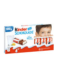 Packaging of Kinder Chocolate with Milk Cream, showing a child peeking from behind the box and the Kinder logo with a splash of milk.