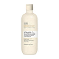 A light yellow plastic bottle of Baylis & Harding Kindness+ Vitamin C + Niacinamide Body Wash with a pump dispenser, labeled with the product name and branding.