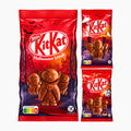Nestle KitKat Halloween break milk chocolate figures packaging shown on a light gray background, with one large bag and two smaller individual packs to the right. The packaging is predominantly red with purple lower sections and features KitKat characters in chocolate form, bats, a haunted house, and Halloween imagery.