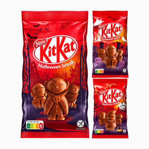 Nestle KitKat Halloween break milk chocolate figures packaging shown on a light gray background, with one large bag and two smaller individual packs to the right. The packaging is predominantly red with purple lower sections and features KitKat characters in chocolate form, bats, a haunted house, and Halloween imagery.