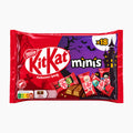 Nestlé KitKat minis Halloween break in a red and purple 18-piece candy pack, featuring spooky illustrations of a haunted house, bats, and ghosts, with several KitKat minis shown on the front.
