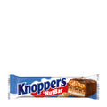 Packaging of Knoppers NutBar Wafer Bar with the product visible through the transparent section of the packaging. The bar is coated with milk chocolate and has chopped hazelnuts visible inside.