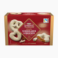 A 250g box of Lambertz White Chocolate Gingerbreads on a clean white background. The packaging is primarily deep red with gold accents, featuring illustrations of white-frosted lebkuchen cookies and a broken cookie.