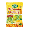 Packaging of Edel Lemon-Honey candies showing the product name and images of the candies, which are shaped like lemon and honeycomb, with a background of a honeycomb pattern.
