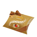 A gold-colored Lindt Lindor pillow pack with assorted chocolate balls, featuring a bow on top.