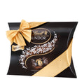 A Lindt Lindor pillow pack with 70% dark chocolate balls, featuring a black and gold color scheme with a decorative ribbon and chocolate designs.