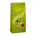Green packaging of Lindt Lindor Pistachio milk chocolate pralines on a white background