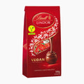 A package of Lindt Lindor Vegan Classic chocolate pralines, 108g, in a red bag with white floral illustrations and a chocolate praline graphic.