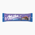 A single Milka Oreo chocolate bar in its original wrapper, shown horizontally against a plain white background. The wrapper is primarily purple with blue ends, featuring the white 'Milka Oreo' logo, a small illustration of a goat, and a depiction of the chocolate cookie on the right side.