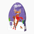 Milka Fun Christmas Gift chocolate box shaped like a stylized chocolate egg, featuring a festive illustration of a reindeer skiing in the snow with purple stars and the Milka logo at the top.