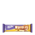 A packaged Milka Waffelini cream wafer bar, with the product visible through the clear window of the packaging.