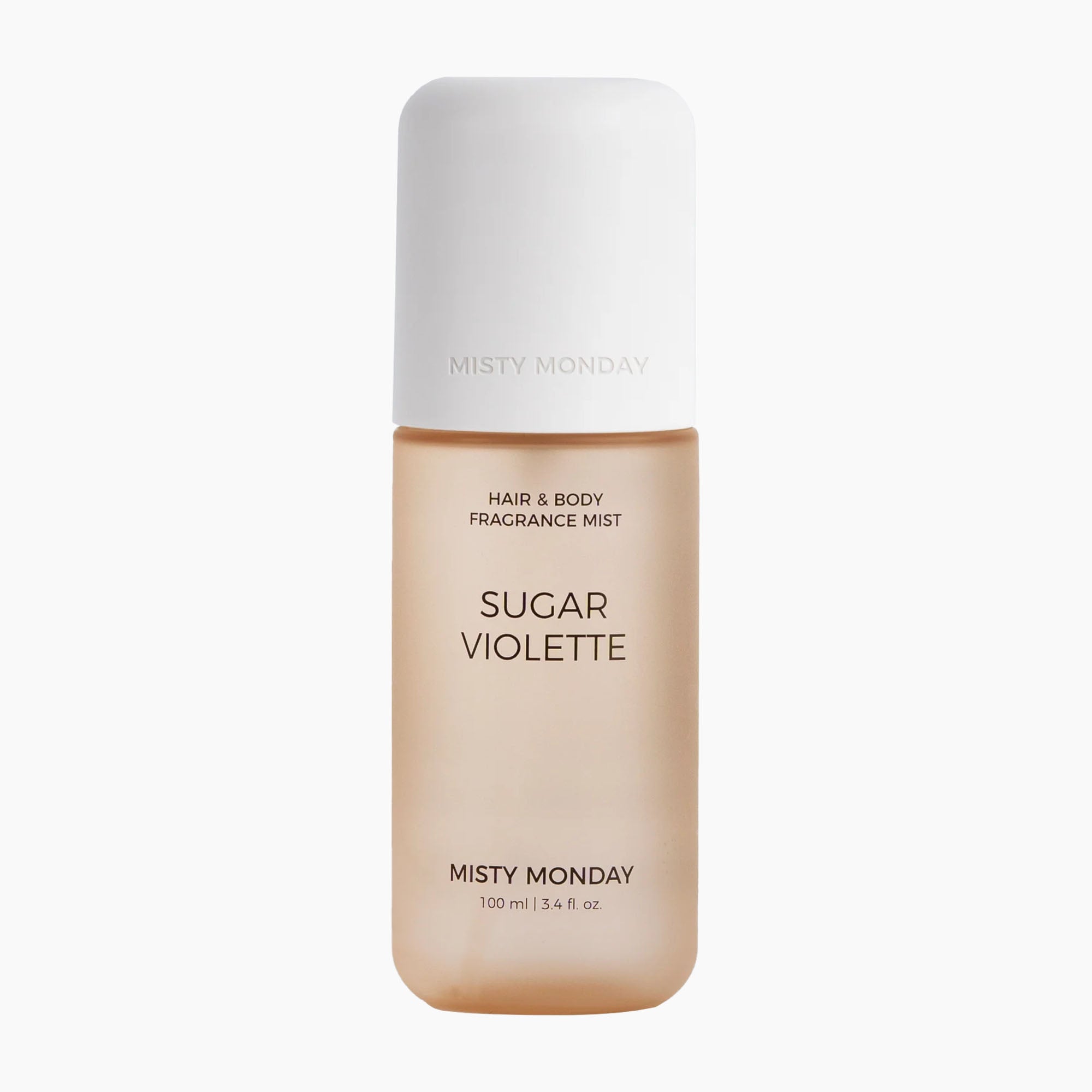A bottle of Misty Monday Sugar Violette hair and body fragrance mist, featuring a warm beige body and a white cap, centered on a light gray background.