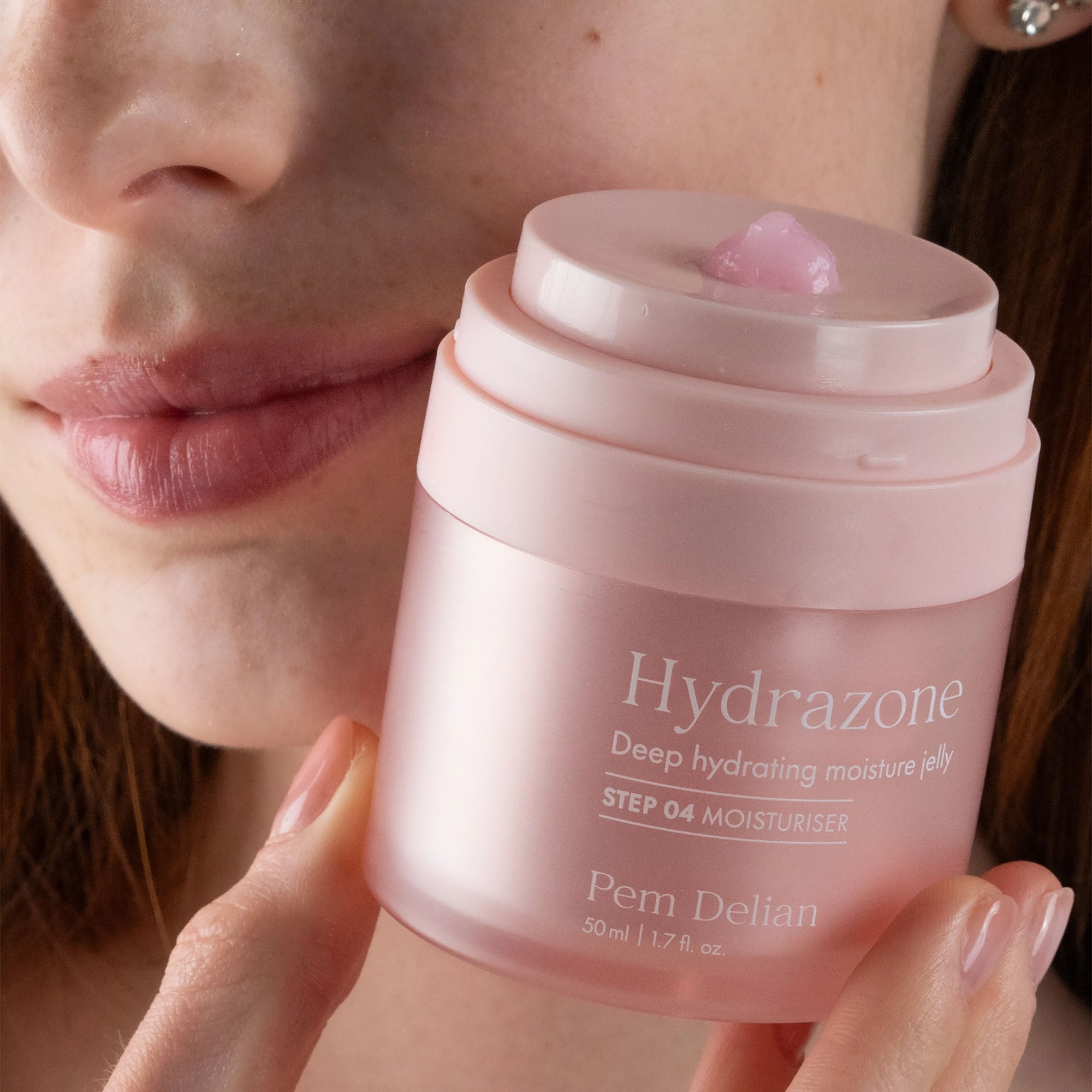 Person holding a pink jar of Hydrazone deep hydrating moisture jelly