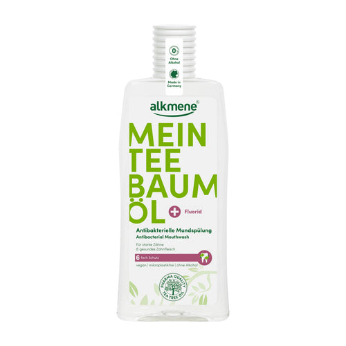 A bottle of Alkmene My Tea Tree Oil Mouthwash with Fluorid, featuring a white bottle with bold green text and a ribbed white cap, set against a plain white background.