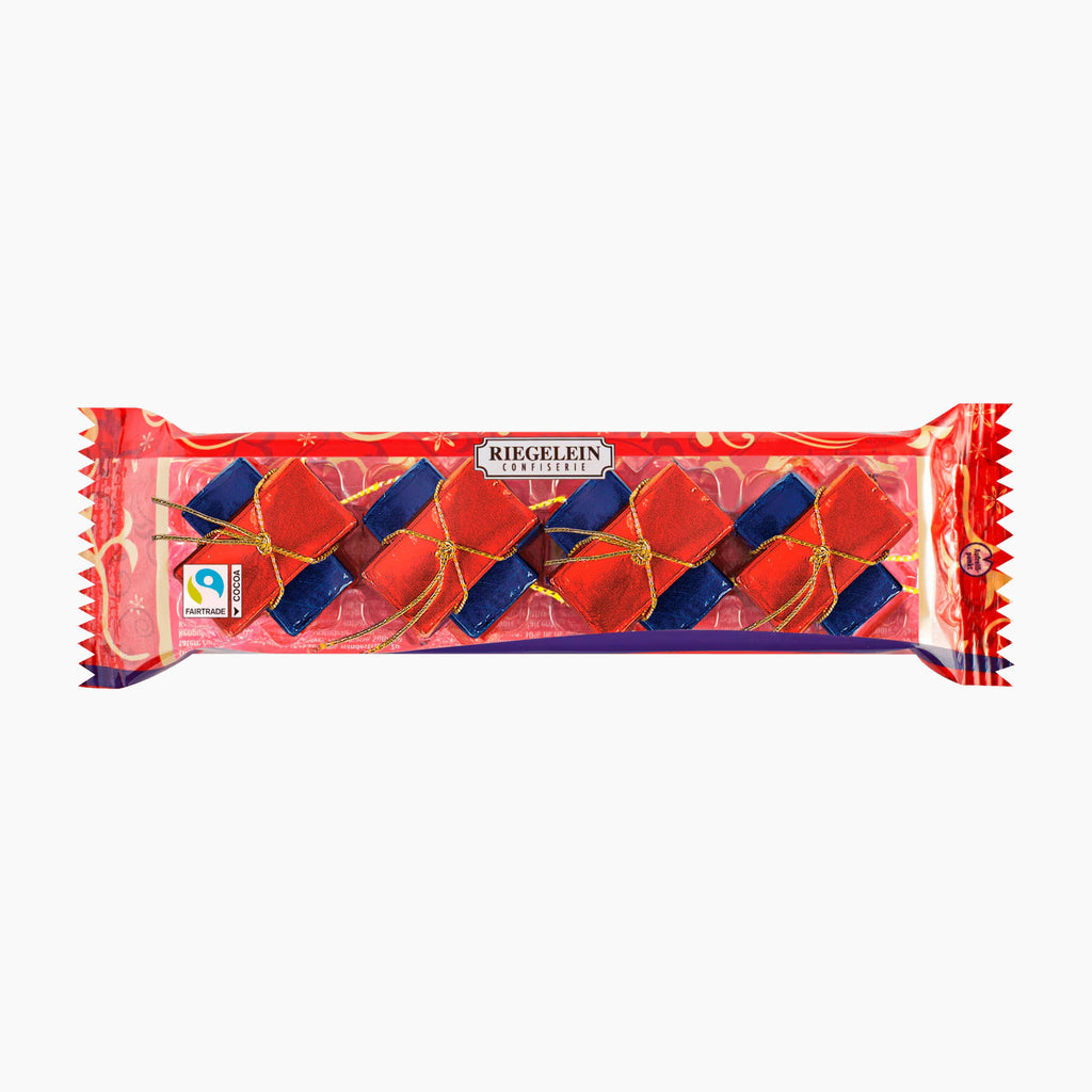 Riegelein Napolitains chocolate bars in its red and clear wrapper, showing the red and blue paper cracker candies inside, on a plain white background.