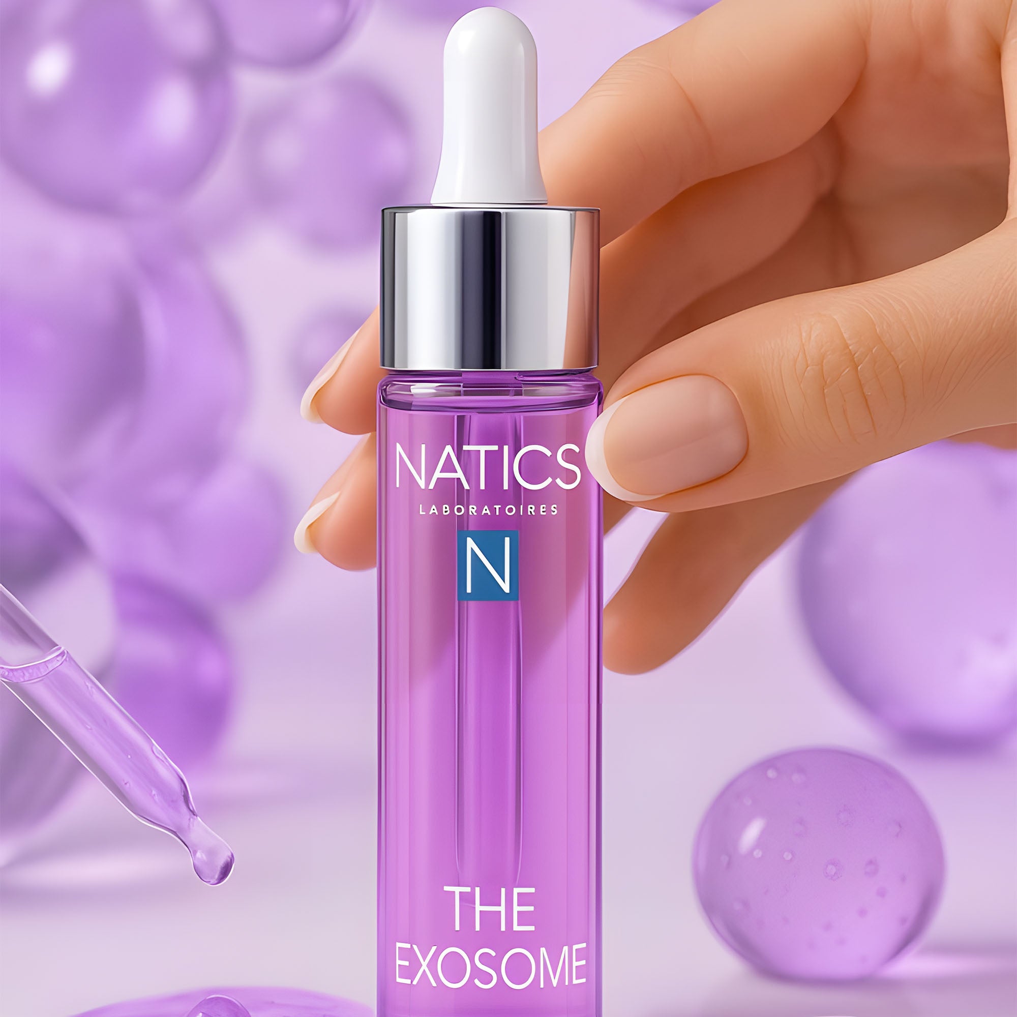 Hand holding a Natics skincare dropper bottle with a purple background
