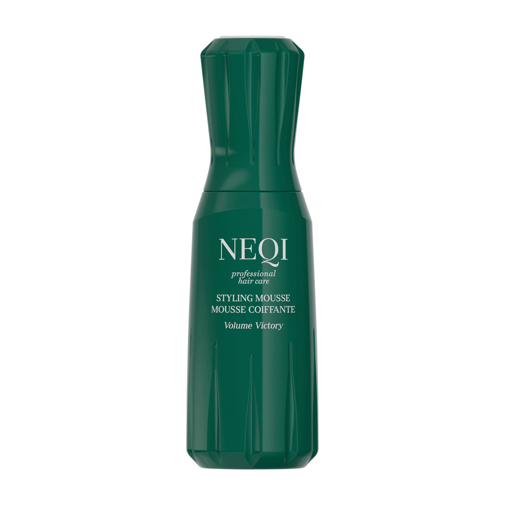 Green bottle of NEQI Volume Victory styling mousse on a white background