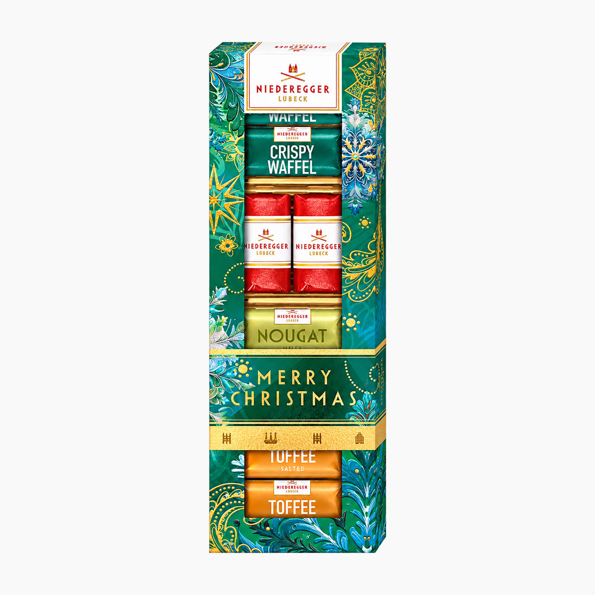 Niederegger Master Selection Merry Christmas chocolate pralines gift set in a tall decorative box, featuring Crispy Waffel, Marzipan, Nougat, and Toffee chocolates with festive green, red, and gold holiday packaging.