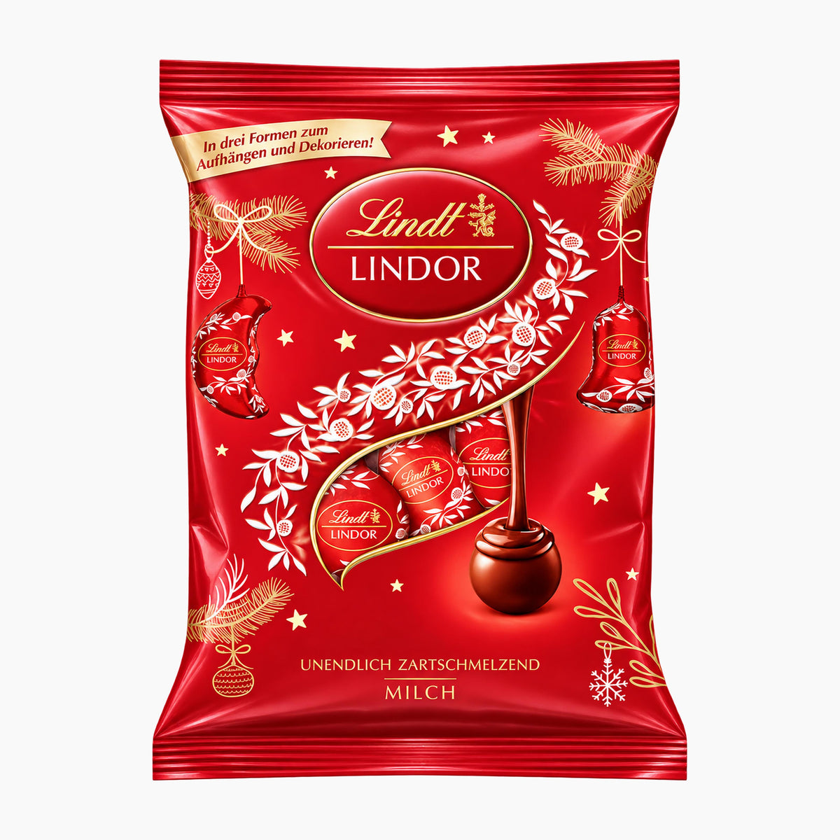 A red bag of Lindt Lindor milk chocolate christmas tree ornaments with gold and white decorative graphics, photographed on a plain light gray background.