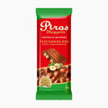 A single packaged Piros Mogyoros hazelnut milk chocolate bar, in a red and green wrapper on a plain light gray background.