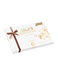Lindt Pralines Fine Nut-Edition box with a brown ribbon on a white background