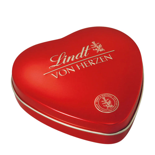 Red heart-shaped Lindt Pralines metal tin on a white background