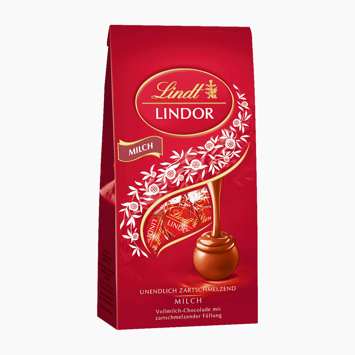 A 100g package of Lindt Lindor Milk Chocolate pralines with a rich red background, featuring the Lindt logo, white floral illustrations, and a golden swirl leading to a milk chocolate piece.