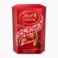 A red Lindt Lindor milk chocolate 50 g box with a clear window showing several wrapped chocolates, photographed on a plain light gray background.