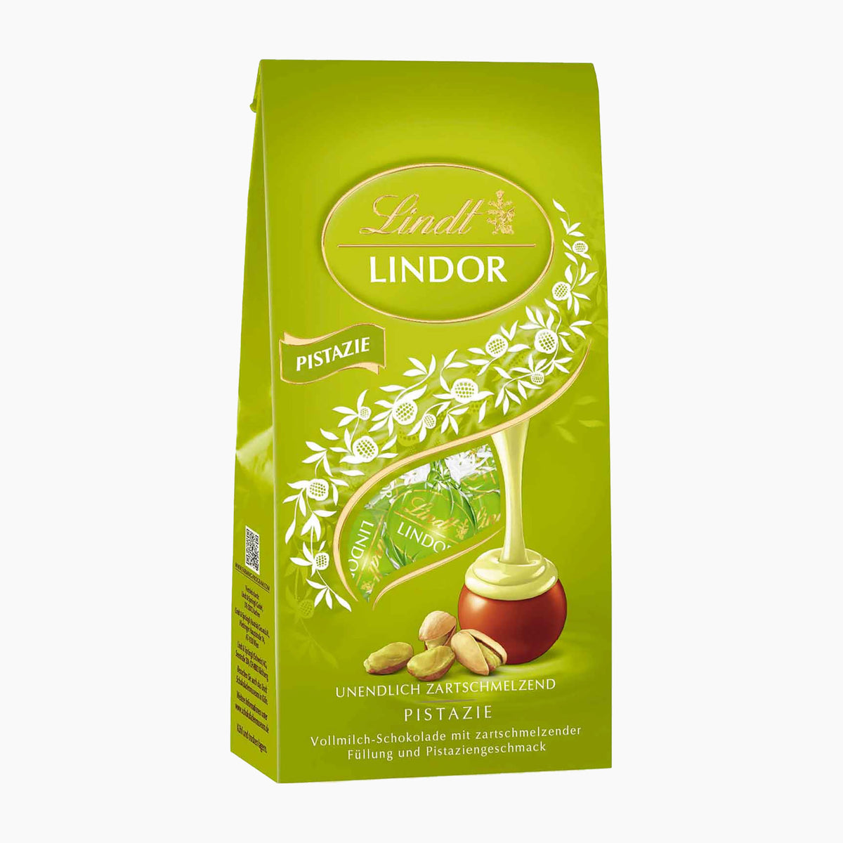 A 100g pack of Lindt Lindor Pistachio chocolate pralines, featuring a bright green bag with illustrations of pistachio nuts, white flowers, and a golden drizzle of chocolate.