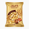 A gold bag of Lindt Nougat chocolate pralines, featuring the Lindt logo, illustrations of wrapped chocolates, and a single chocolate piece on a plain white background.
