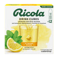 Ricola Drink Cubes packaging with lemon, mint, and glass of drink on a white background