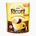 A 150 g package of Nestlé Ricoré Instant Coffee with Chicory, featuring a bright yellow and brown stand-up pouch with an illustration of a coffee cup, coffee beans, and a small flower on a white background.