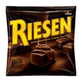 Dark brown packaging of Storck Riesen dark chocolate caramel chewy candy, 105g, on a white background.