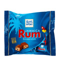 Packaging of Ritter Sport Jamaica Rum Milk Chocolate Bites featuring an image of a palm tree, a parrot, and the chocolate pieces with nuts.