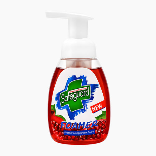 A bottle of Safeguard Foamer Fresh Pomegranate foam soap with a white pump dispenser, filled with red liquid and featuring a white, green, and red label with pomegranate illustrations.