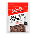 Packaging of Rheila Salmiak pastilles, showing the product name and extra-strong label, with the licorice pastilles visible through the clear window.