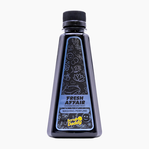 A bottle of Scrub Daddy Fresh Affair Washing Perfume, featuring a black plastic bottle with a black cap and a blue and black label with white line art illustrations, set against a plain white background.
